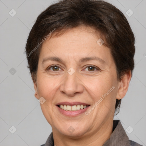 Joyful white adult female with short  brown hair and brown eyes