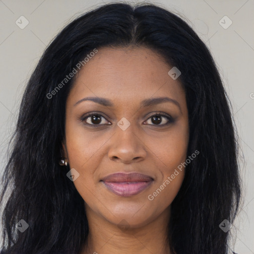 Joyful black young-adult female with long  black hair and brown eyes