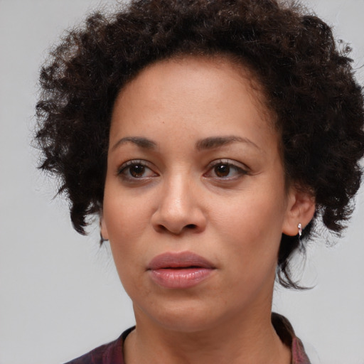 Joyful black adult female with short  brown hair and brown eyes