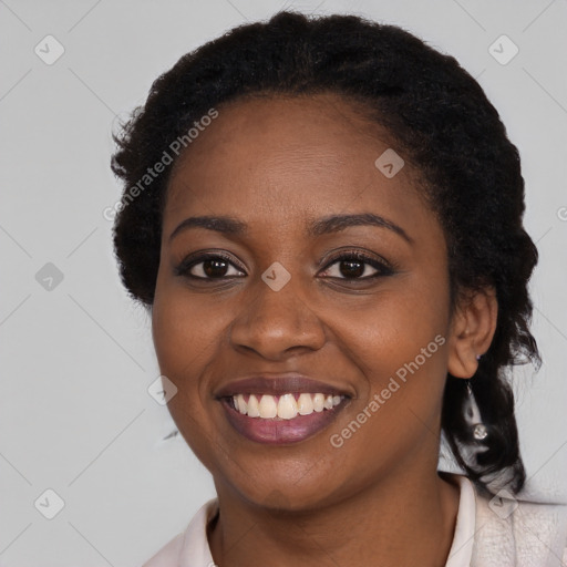 Joyful black young-adult female with long  black hair and brown eyes