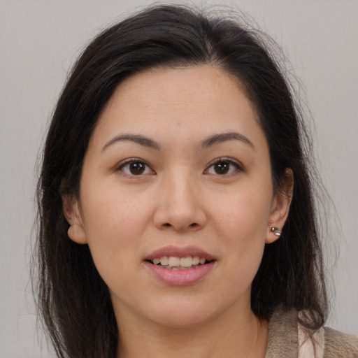 Joyful white young-adult female with long  brown hair and brown eyes