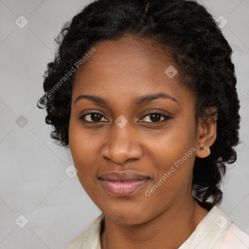 Joyful black young-adult female with long  black hair and brown eyes