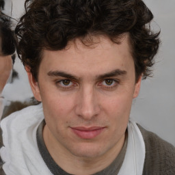 Joyful white young-adult male with medium  brown hair and brown eyes