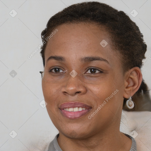 Joyful black young-adult female with short  brown hair and brown eyes