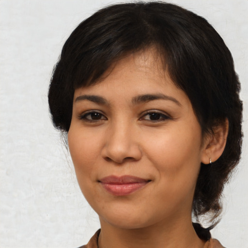 Joyful latino young-adult female with medium  black hair and brown eyes