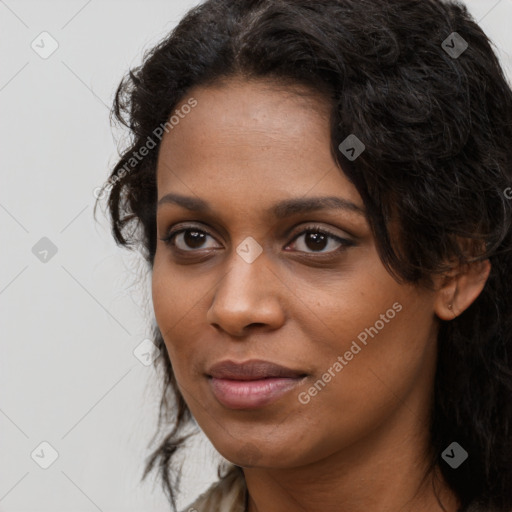 Joyful black young-adult female with long  brown hair and brown eyes