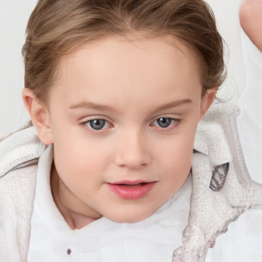 Joyful white child female with medium  brown hair and blue eyes