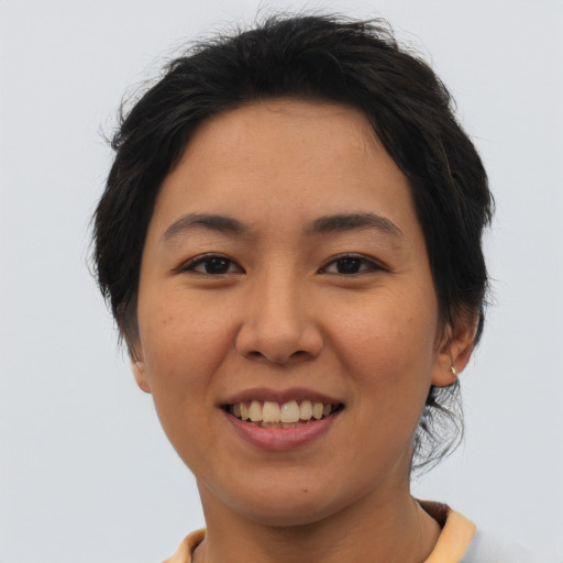 Joyful asian young-adult female with short  brown hair and brown eyes