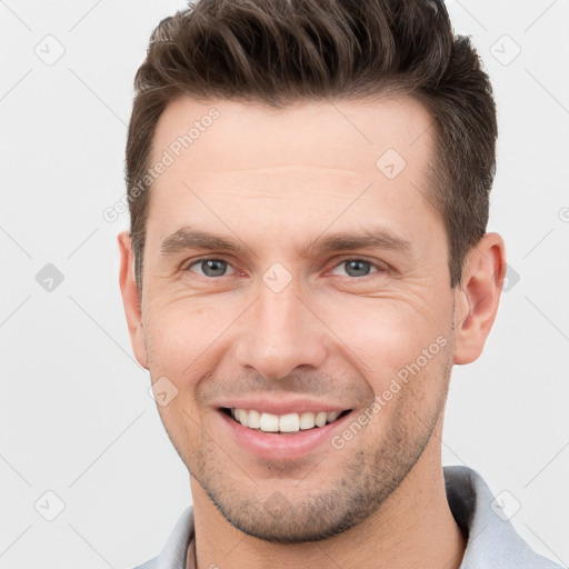 Joyful white young-adult male with short  brown hair and brown eyes