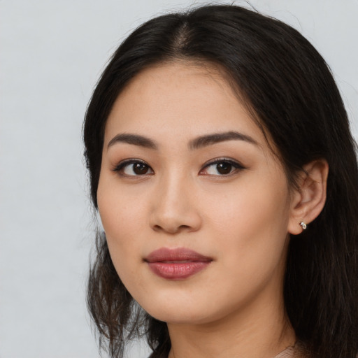 Joyful asian young-adult female with long  black hair and brown eyes