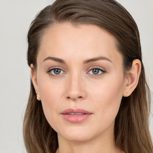 Joyful white young-adult female with long  brown hair and grey eyes