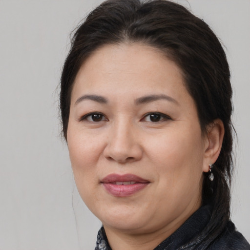 Joyful white adult female with medium  brown hair and brown eyes