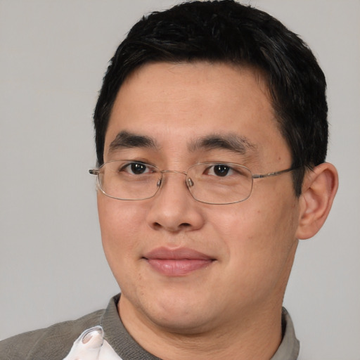 Joyful asian adult male with short  black hair and brown eyes