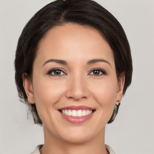 Joyful white young-adult female with medium  brown hair and brown eyes