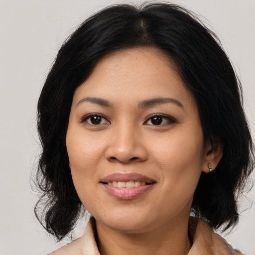 Joyful asian young-adult female with medium  black hair and brown eyes
