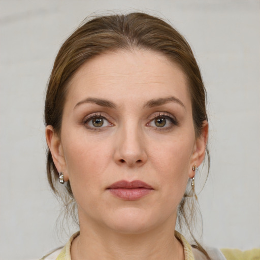 Joyful white young-adult female with medium  brown hair and grey eyes