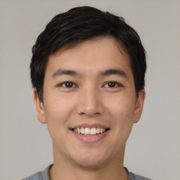 Joyful asian young-adult male with short  black hair and brown eyes