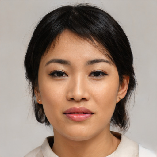 Joyful asian young-adult female with medium  black hair and brown eyes