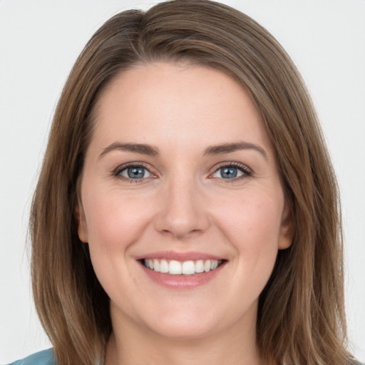 Joyful white young-adult female with long  brown hair and grey eyes