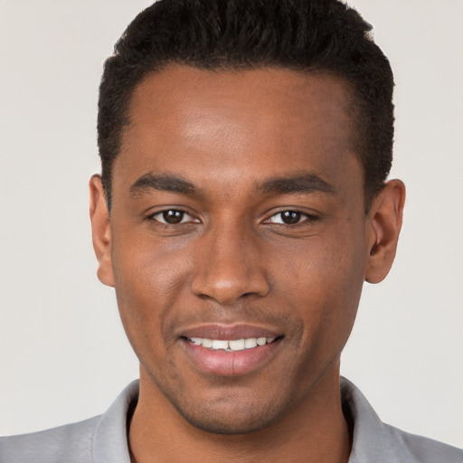 Joyful black young-adult male with short  brown hair and brown eyes