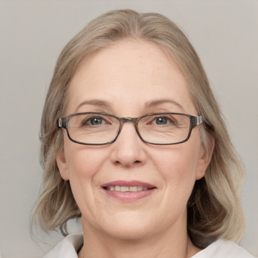 Joyful white adult female with medium  brown hair and blue eyes