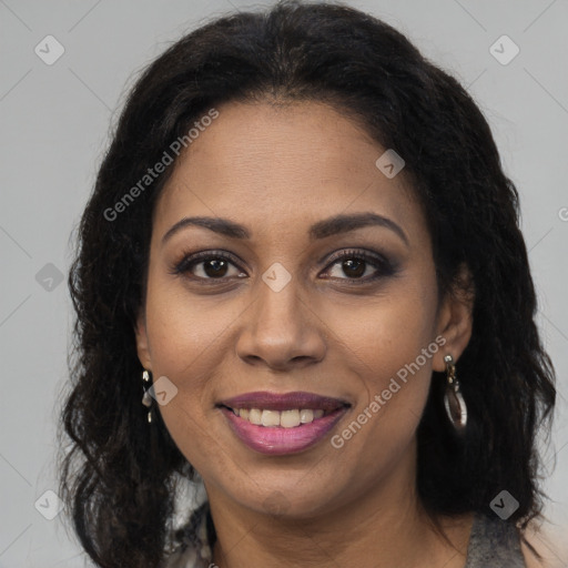 Joyful black young-adult female with long  brown hair and brown eyes