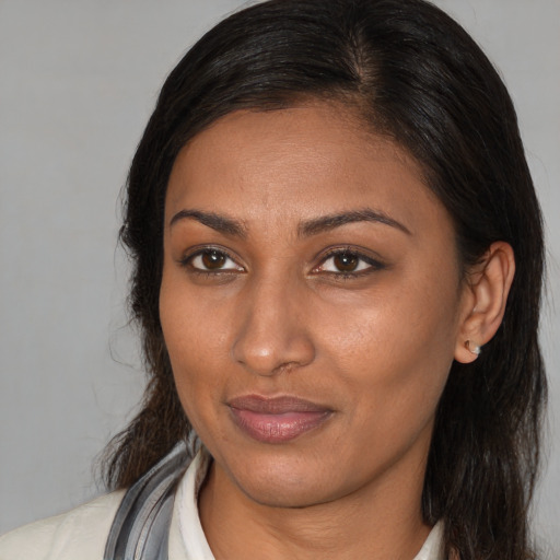 Joyful asian adult female with medium  brown hair and brown eyes