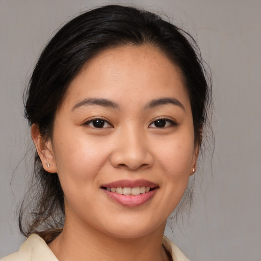 Joyful asian young-adult female with medium  brown hair and brown eyes