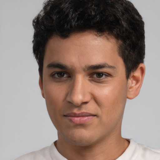 Joyful white young-adult male with short  black hair and brown eyes