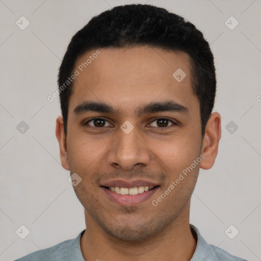 Joyful latino young-adult male with short  black hair and brown eyes