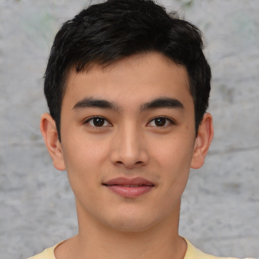 Joyful asian young-adult male with short  black hair and brown eyes