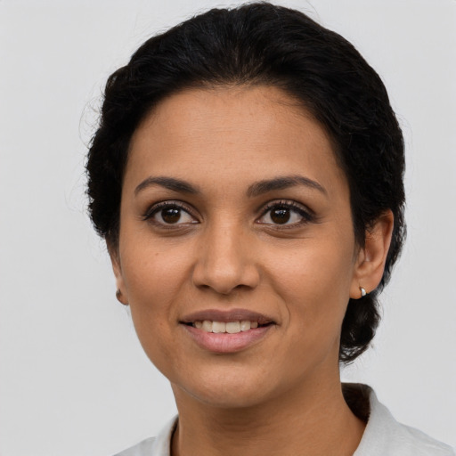 Joyful latino young-adult female with medium  black hair and brown eyes