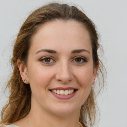 Joyful white young-adult female with medium  brown hair and grey eyes