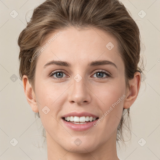 Joyful white young-adult female with medium  brown hair and grey eyes