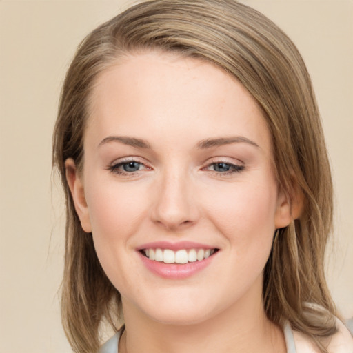 Joyful white young-adult female with long  brown hair and green eyes