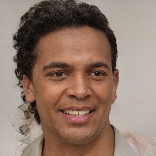 Joyful latino young-adult male with short  brown hair and brown eyes