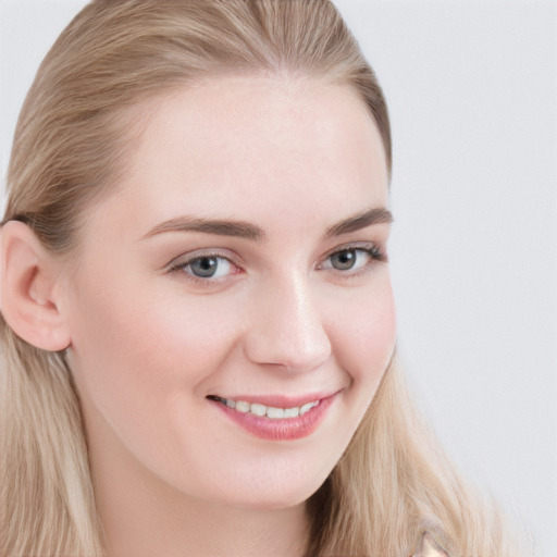 Joyful white young-adult female with long  brown hair and blue eyes