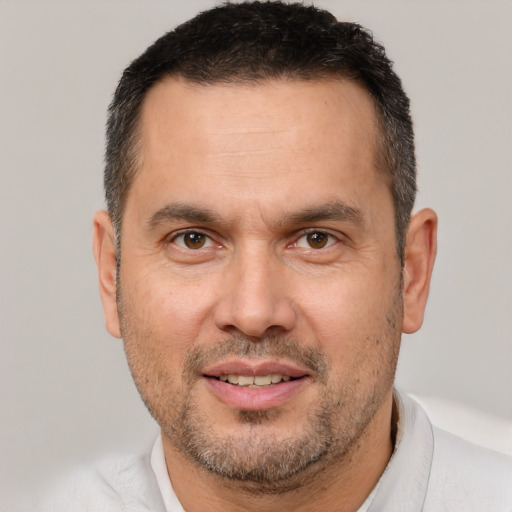 Joyful white adult male with short  brown hair and brown eyes