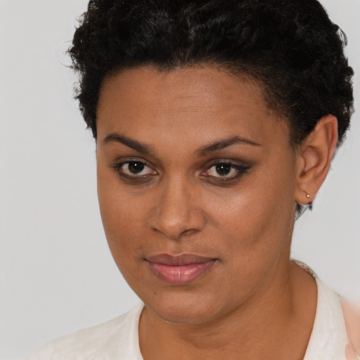 Joyful black young-adult female with short  brown hair and brown eyes
