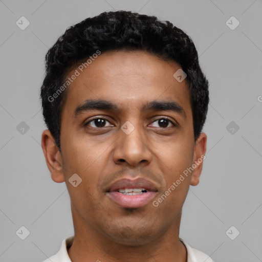 Joyful latino young-adult male with short  black hair and brown eyes