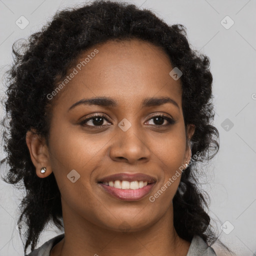 Joyful black young-adult female with long  brown hair and brown eyes