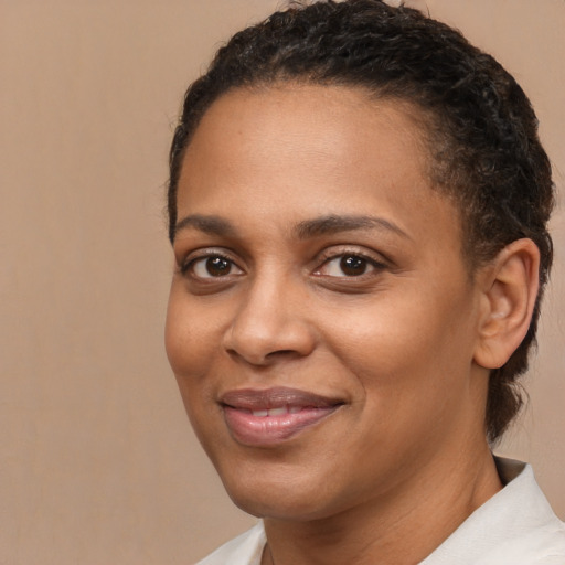 Joyful black young-adult female with short  brown hair and brown eyes