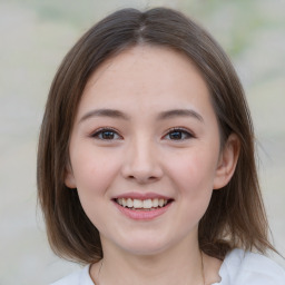 Joyful white child female with medium  brown hair and brown eyes