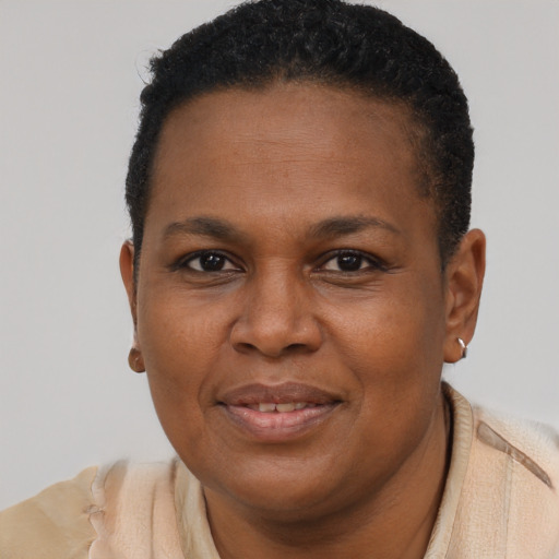 Joyful black young-adult female with short  brown hair and brown eyes