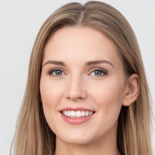 Joyful white young-adult female with long  brown hair and grey eyes