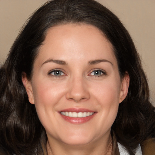 Joyful white adult female with long  brown hair and brown eyes