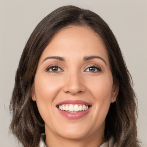 Joyful white young-adult female with medium  brown hair and brown eyes