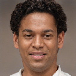 Joyful latino young-adult male with short  brown hair and brown eyes