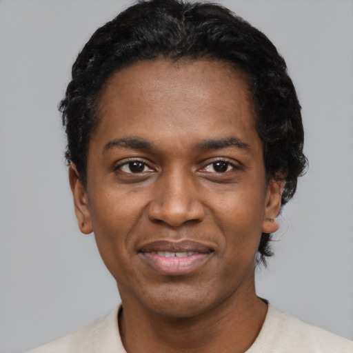 Joyful black adult male with short  black hair and brown eyes