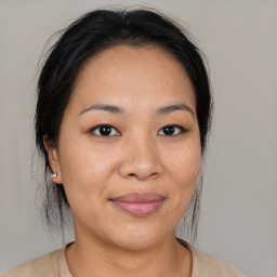 Joyful asian young-adult female with medium  black hair and brown eyes